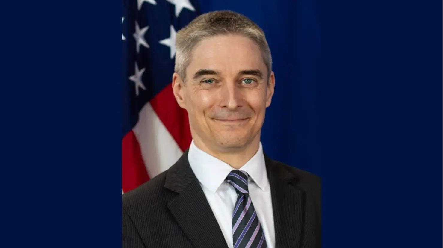 Drew Hoster es egresado de la Universidad de Kansas y de la Facultad de Derecho de la Universidad George Mason, y antes de se uniera al Servicio Exterior de Estados Unidos en 2004, ejerció como abogado litigante en Portland, Oregon